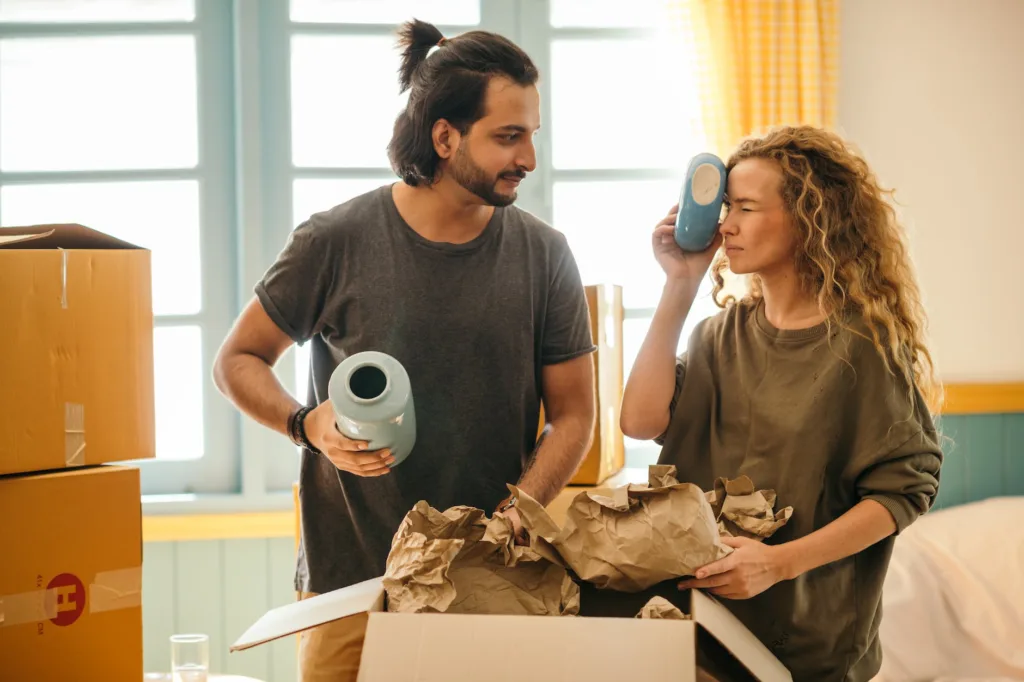 friendly diverse couple unpacking fragile things after relocation, open relationship definition