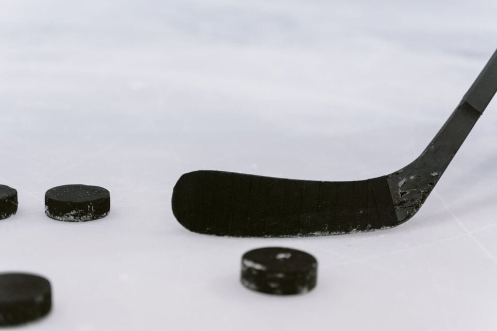 U20 MM-kisat 2023, close up shot of a hockey puck and hockey stick