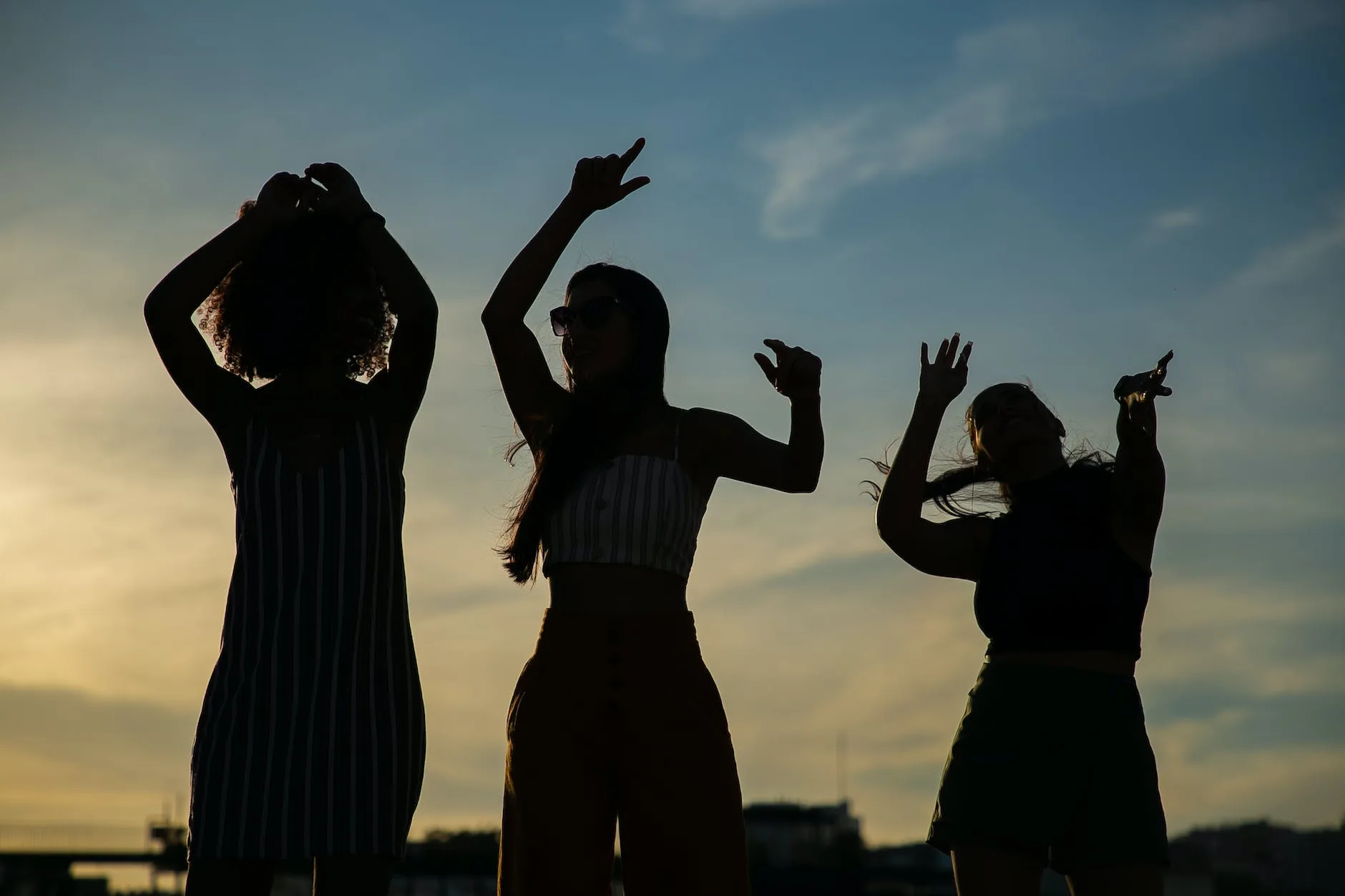 Photo by Kampus Production on <a href="https://www.pexels.com/photo/anonymous-girlfriends-dancing-against-sunset-sky-5935232/" rel="nofollow">Pexels.com</a>