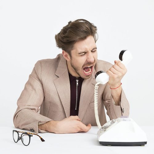 Outlook is not preventing spam email at all. Picture: Moose Photos on <a href="https://www.pexels.com/photo/man-wearing-brown-suit-jacket-mocking-on-white-telephone-1587014/" rel="nofollow">Pexels.com</a>